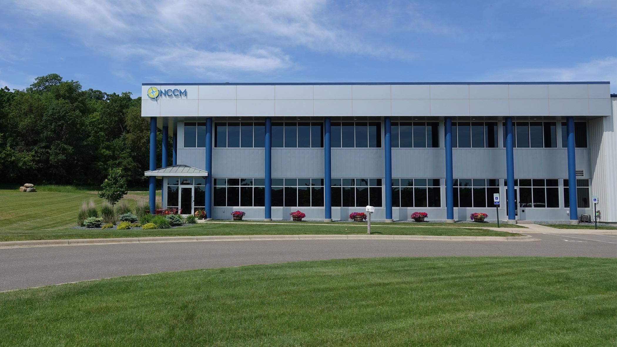 Front view of NCCM Company headquarters during a beautiful summer day